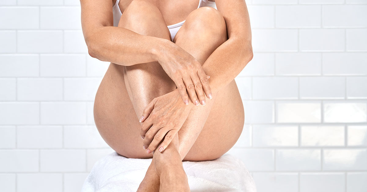 image of woman applying lotion to shoulder
