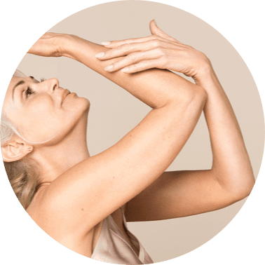 Woman looking at arms - Crepe Erase Skin Cream Treatment
